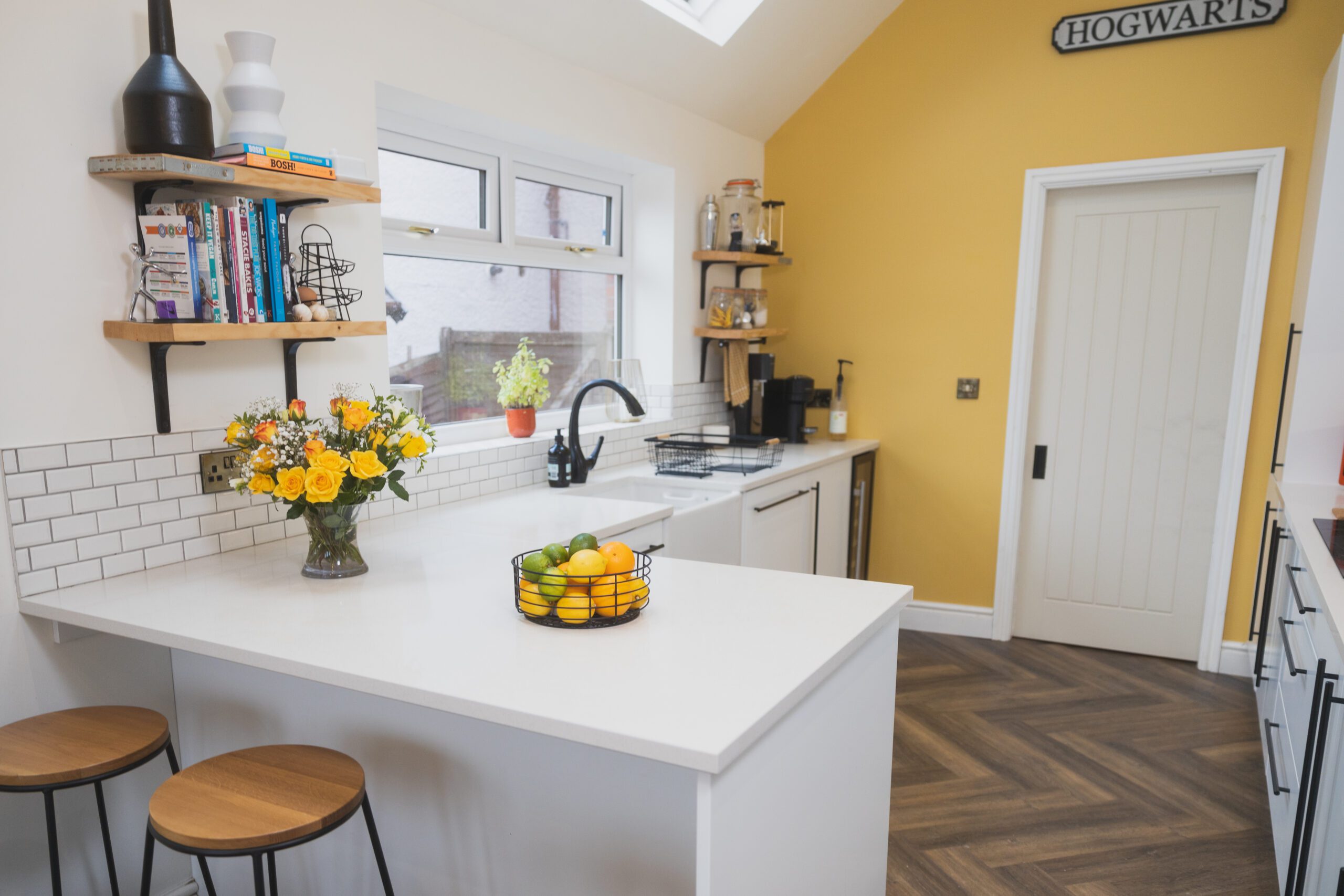 Bright kitchen with an Ice White Quartz breakfast bar and smooth white worktop surface