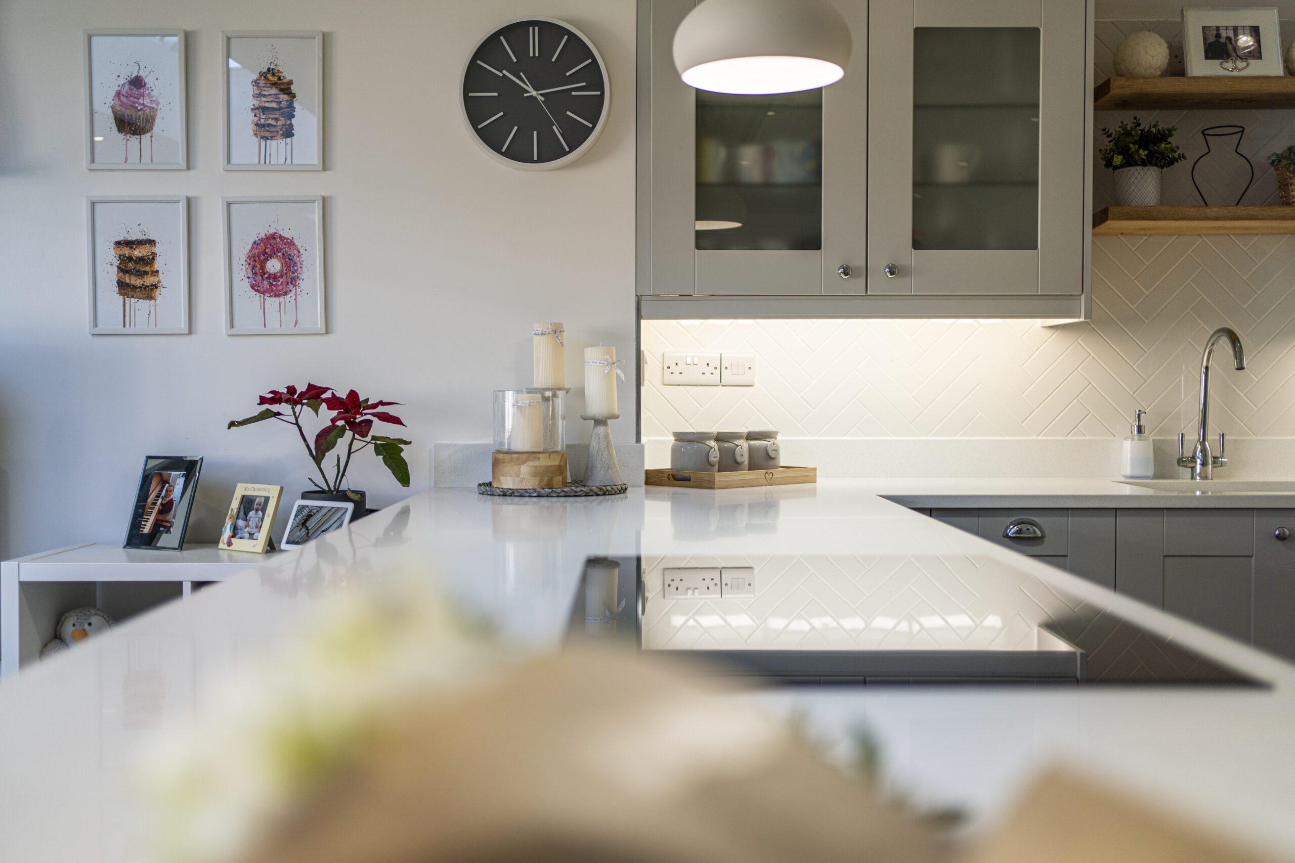 Aspen Shimmer Quartz worktops in a bright kitchen with modern decor and wall shelves