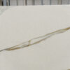 Calacatta Vagli Gold Porcelain slab section with a long flowing gold vein across a white background