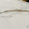 Calacatta Vagli Gold Porcelain close-up showing soft gold and grey veining across a white surface