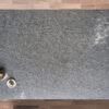 Overhead view of Diamond Galaxy leather Granite worktop showing a dark grey textured surface with subtle natural movement, photographed from above with styling near the edge.