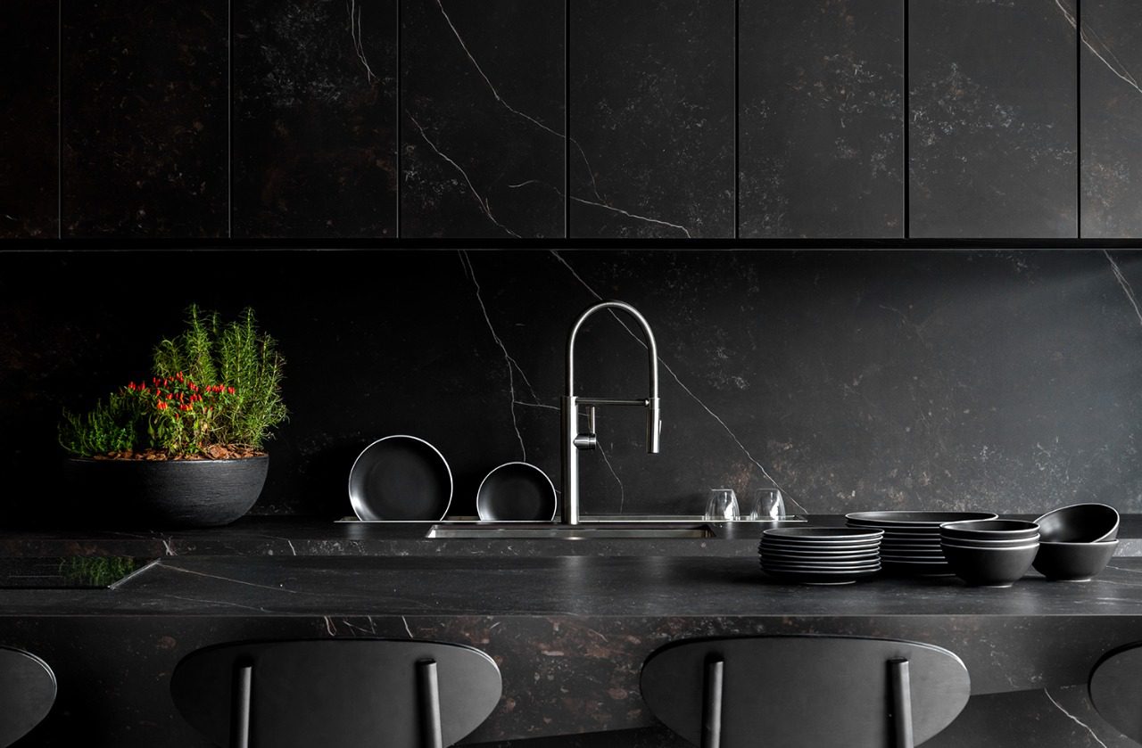 Kelya Porcelain dark worktop run with integrated sink, chrome tap and matching full height splashback