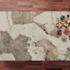 Khalo Porcelain worktop surface in creamy white with bold taupe and gold veining, photographed from above with small bowls at the edge