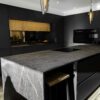 Laurent Porcelain worktops in a modern dark kitchen with bold veining and large central island
