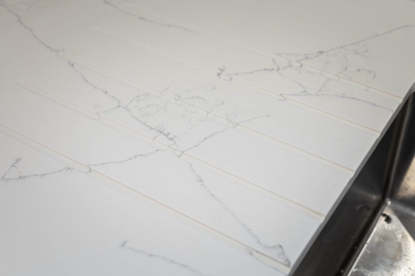 White Macaubus Quartz worktop close-up showing delicate grey veining and a clean white finish