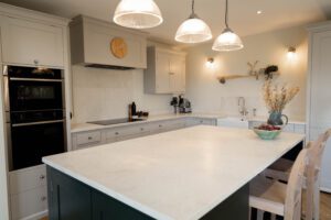 White Concrete Quartz island worktop in a light kitchen showing smooth surface finish and clean edge lines