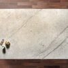 Overhead view of an Ivory Spice Granite worktop showing warm cream tones and soft natural veining, photographed from above with a small styled tray in the corner.