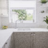 Bluetta Carrara Quartz sink run by a window showing a smooth white surface and clean finish
