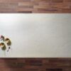 Statuario Bianco Porcelain slab displayed on a wooden surface showing soft grey veining