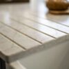 Super White Quartz worktop close-up showing integrated drainer grooves and clean edge detail on a light stone-effect surface