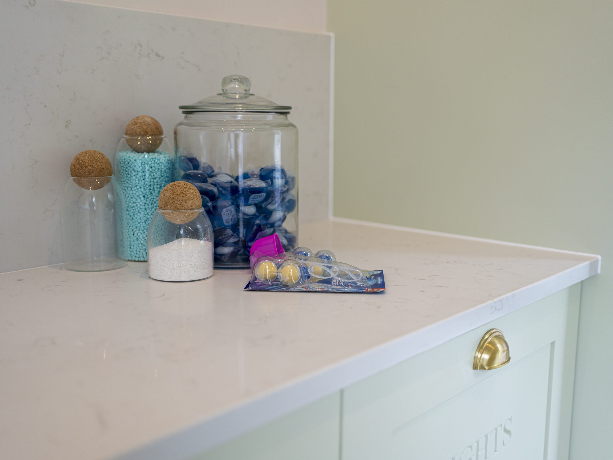 Carrara Quartz worktop with storage jars and accessories in a modern utility room