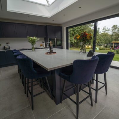 Modern kitchen with Carrara Quartz island beneath skylight