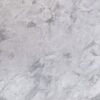 Close up slab photo of Bianco Eclipsia Granite showing soft pale grey clouding and gentle natural movement across a light stone surface.