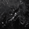 Midnight Black Quartz slab close-up showing dark black stone-effect surface with smoky movement and lighter mineral markings