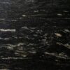 Close up slab photo of Cosmic Black Granite showing sweeping veining and layered mineral patterning through the dark surface.