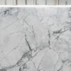 Calacatta Super White Porcelain close-up showing a white marble effect background with bold grey veining and fine hairline detail