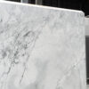 Calacatta Super White Porcelain slab edge view showing a bright white base with layered grey veining and soft shading