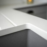 Classic White Quartz worktop close-up showing an inset sink cut-out with clean squared edges and smooth finish