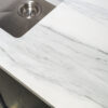 Bianco Lasa Porcelain worktop corner detail with soft grey veining beside an undermount sink