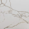 Calacatta Oro Porcelain surface with white background and gold veining
