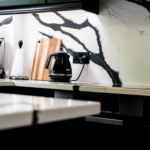Black Calacatta Quartz splashback detail with bold black veining behind the worktop and appliance area