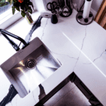 Black Calacatta Quartz worktop with inset stainless steel sink shown from above with bold veining nearby