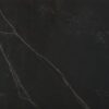 Kelya Porcelain close up in deep charcoal featuring a prominent white vein and soft speckled texture