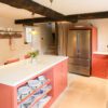 Supreme Calacatta Quartz island worktop in a traditional kitchen showing bright white surface on red base units