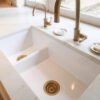 Supreme Calacatta Quartz worktop around a double bowl sink with polished white surface and subtle marble-effect veining