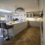 Aspen Shimmer Quartz island adjacent to a modern living area