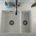 Top view of a white double sink set into Aspen Shimmer Quartz worktops