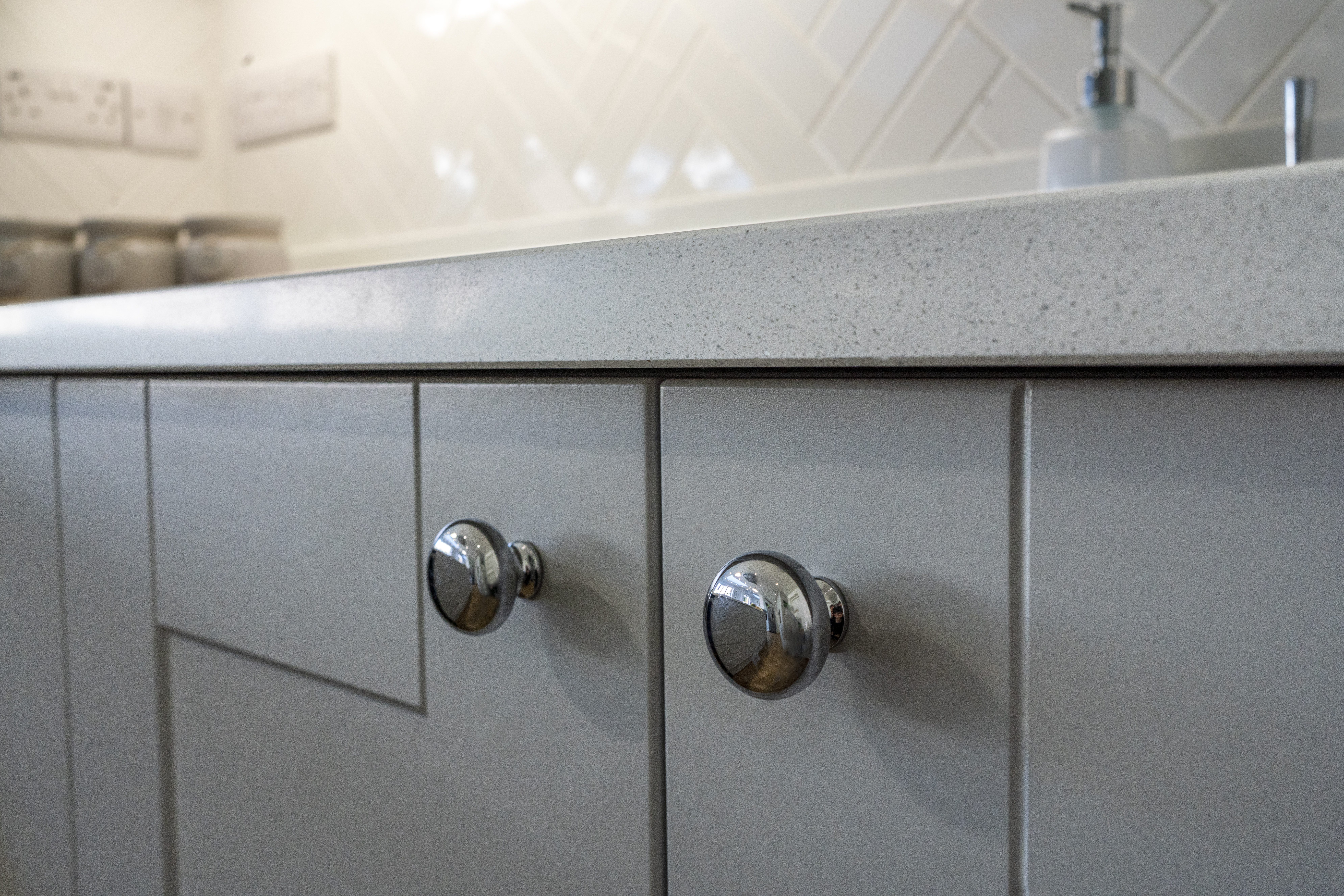 Aspen Shimmer Quartz worktop above grey cabinetry with chrome handles