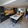 Kitchen dining area with an Olympus White Quartz island worktop showing soft veining across the surface