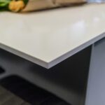 Blanco Zeus Quartz worktop edge close-up showing smooth white surface and clean profile above dark cabinetry