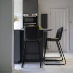 Open-plan kitchen view with Blanco Zeus Quartz island worktop and bar seating shown from a side angle