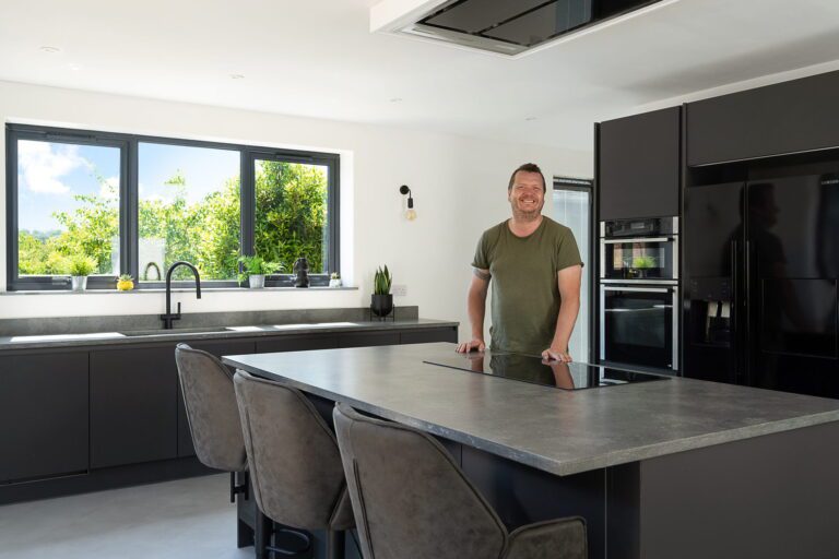 Testimonial kitchen featuring a Grey Concrete Quartz island worktop with concrete-effect finish and overhang seating