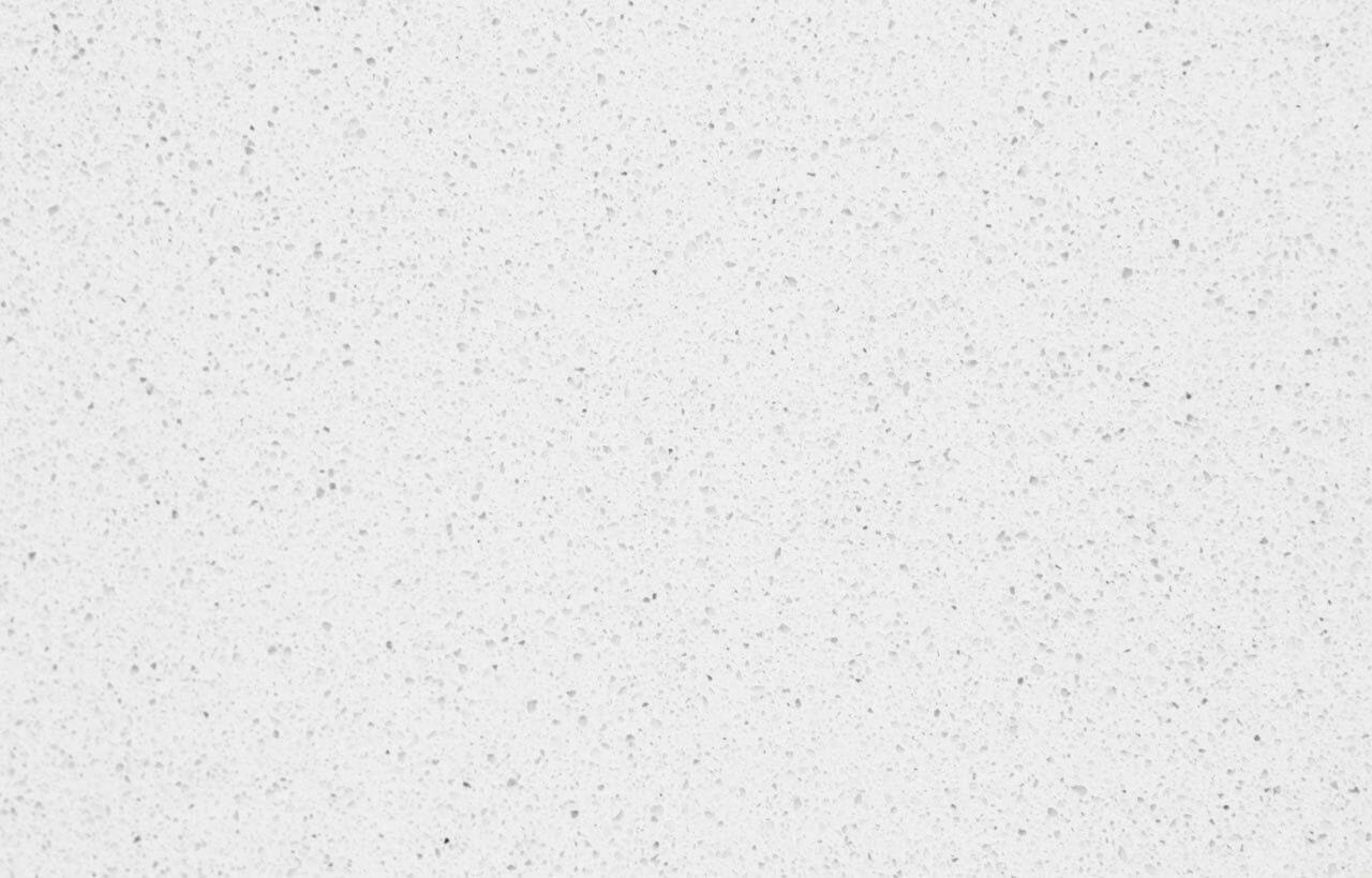 Close-up of a white Quartz surface showing fine speckling and a smooth, uniform finish